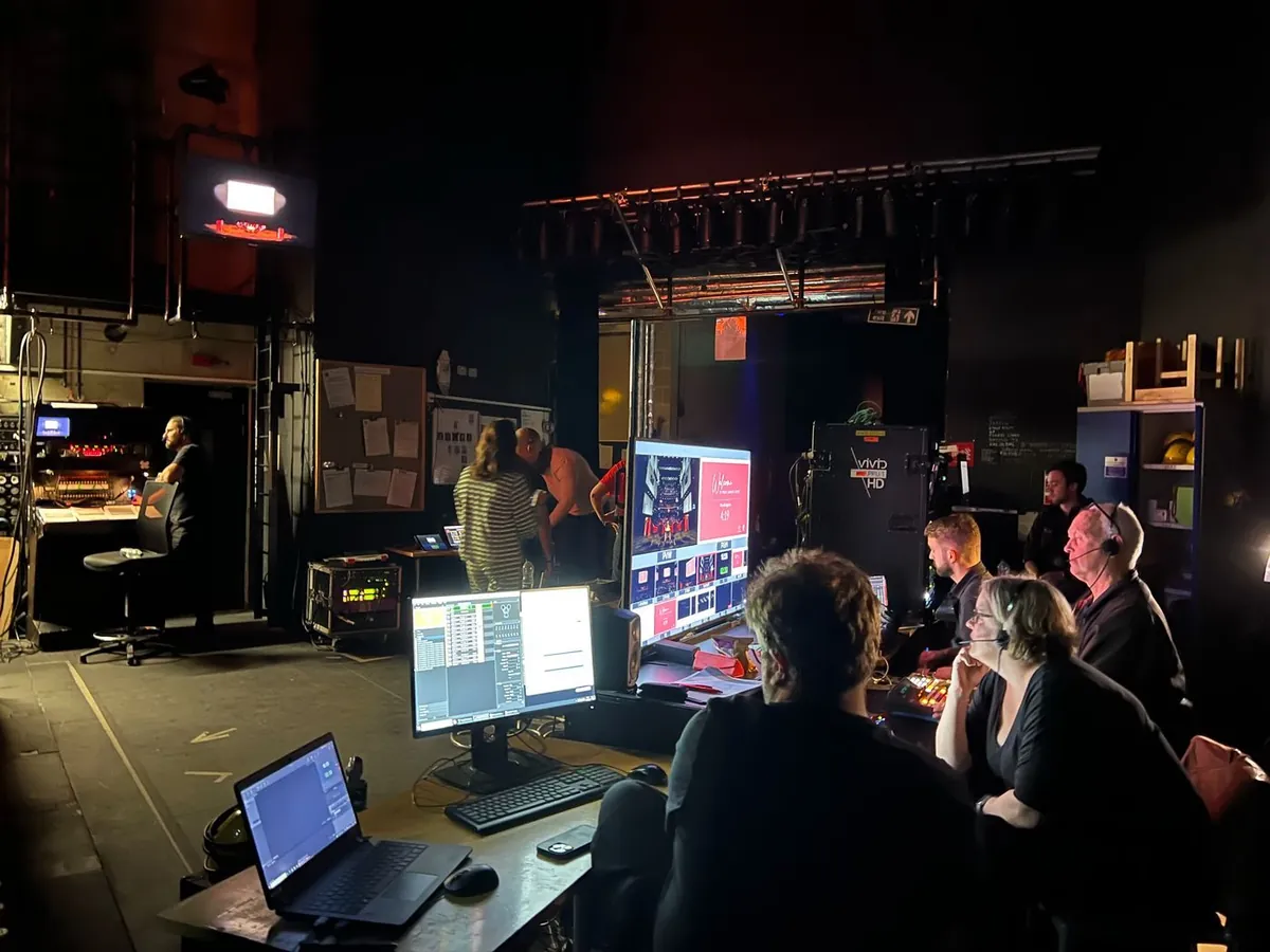 A camera operator and musician at work during a studio filming session