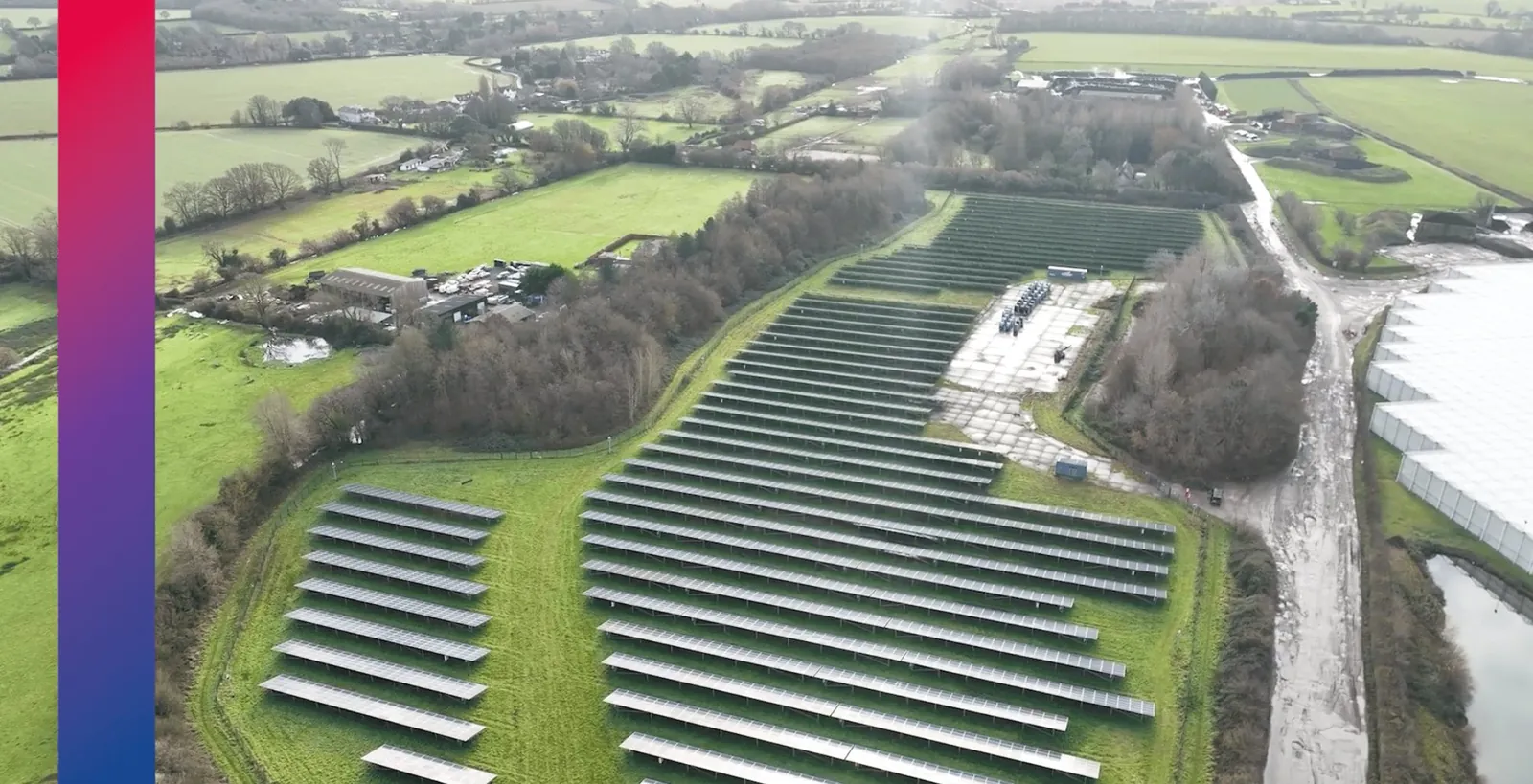 Aerial thumbnail for the npower Business Solutions solar partnership film: rows of solar panels beside green fields, framed by an npower gradient bar